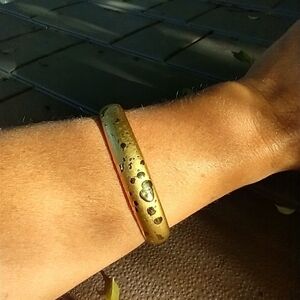 Women's plastic gold tone bangle bracelet.